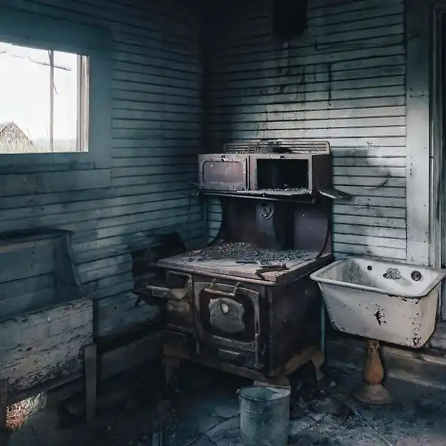 very old kitchen with old wood stove - before view